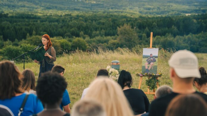 Petra mluví k hostům během posledního rozloučení.